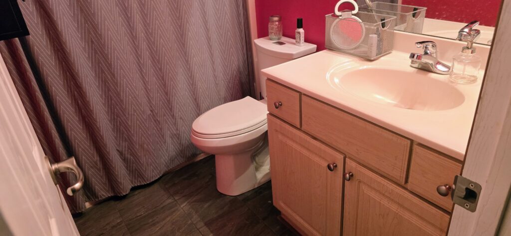 Compact bathroom remodel with modern vanity, sink, and toilet
