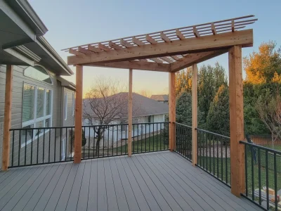 Elevated deck pergola with composite flooring and black railings