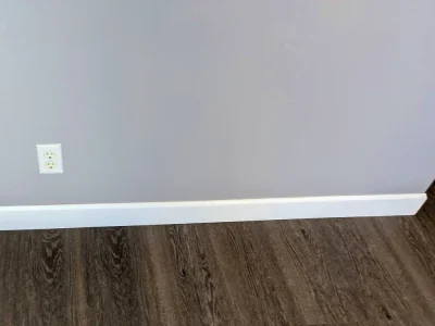 Interior room with white trim baseboards and gray painted walls