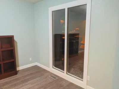 Living room with dark gray vinyl plank flooring and large sliding glass doors